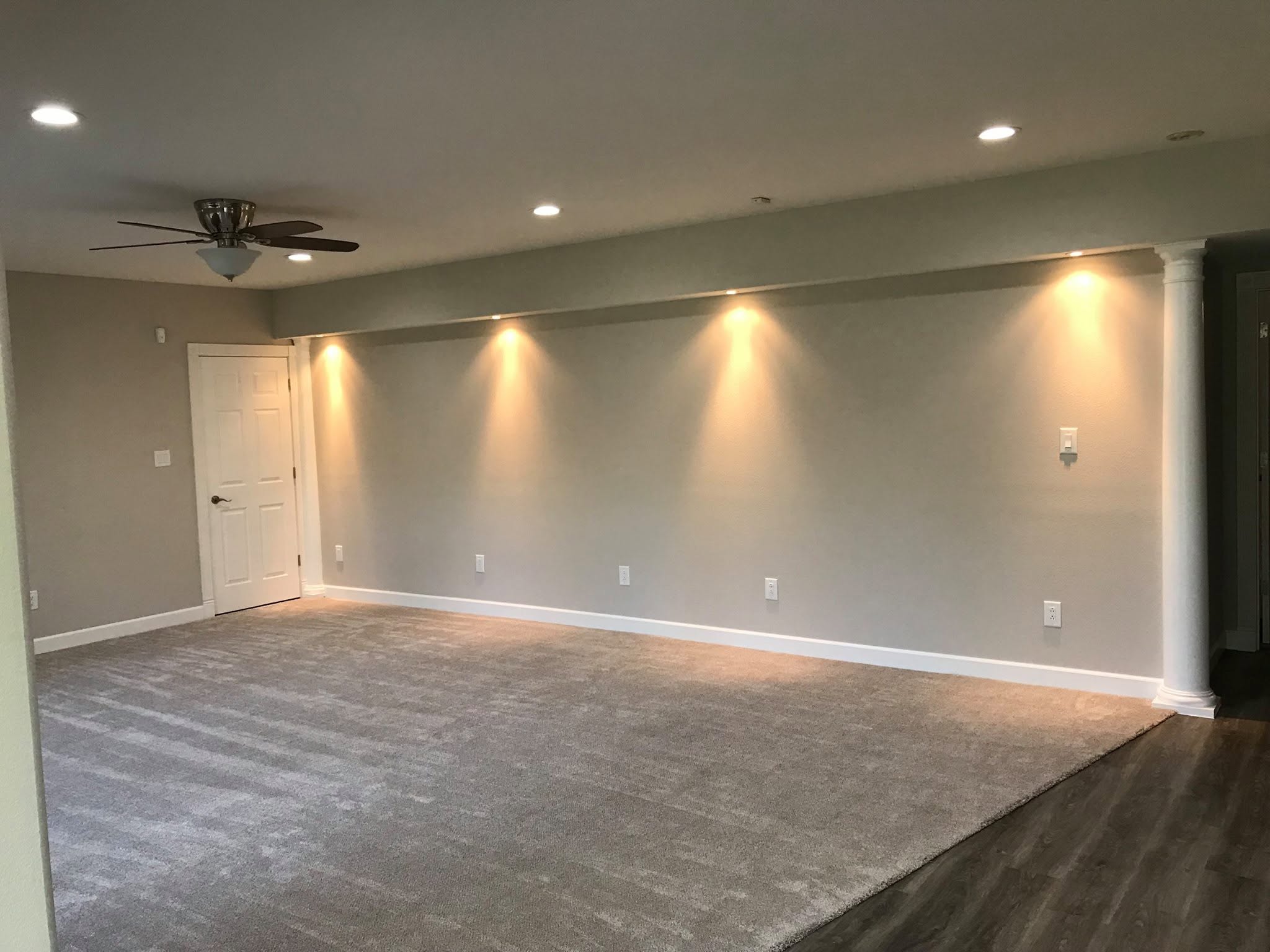 Finished interior renovation with recessed lighting, painted walls, carpet, and wood-look flooring